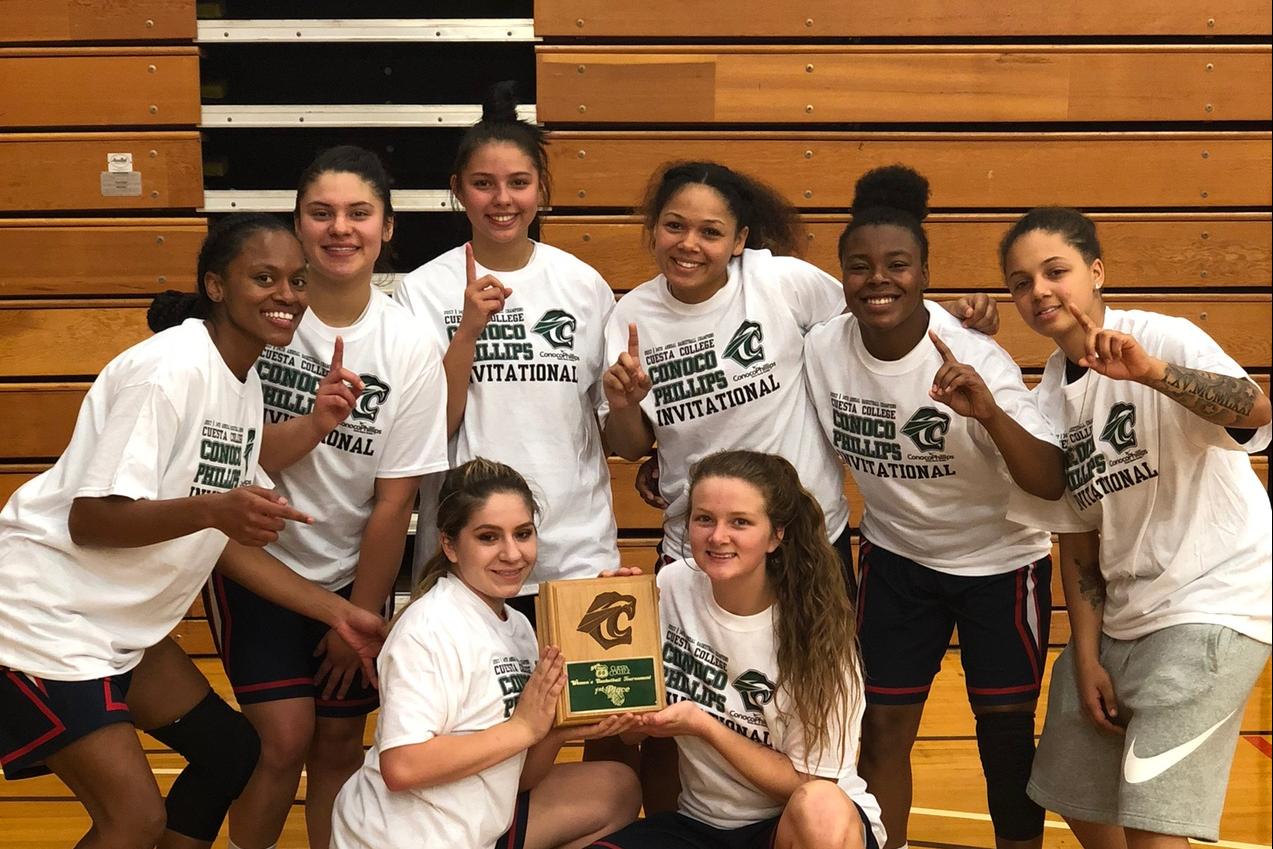 Women's Basketball Team holding the 1st place plaque.
